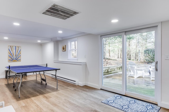 playroom featuring a baseboard heating unit, baseboards, wood finished floors, and recessed lighting