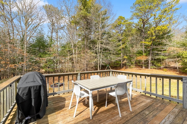 wooden deck featuring area for grilling and outdoor dining space