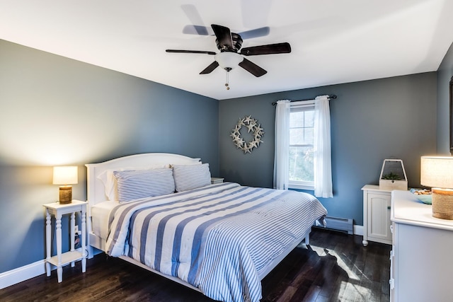 bedroom with a baseboard heating unit, ceiling fan, baseboards, and dark wood finished floors