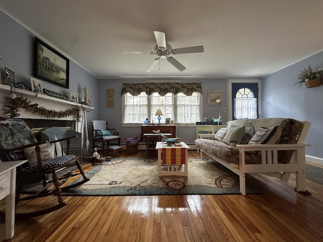 39 Naushon Rd, Dennis Port, MA 02639 - living room with wood finished floors, a fireplace, crown molding, baseboards, and ceiling fan