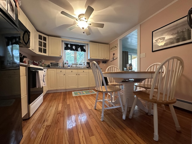 39 Naushon Rd, Dennis Port, MA 02639 - kitchen with a ceiling fan, refrigerator, light wood-type flooring, range, and black microwave