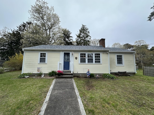 39 Naushon Rd, Dennis Port, MA 02639 - manufactured / mobile home with a chimney, a front yard, a shingled roof, and fence