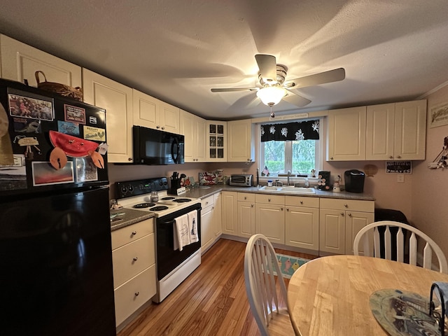 39 Naushon Rd, Dennis Port, MA 02639 - kitchen featuring a ceiling fan, light wood-style flooring, a sink, black appliances, and white cabinets