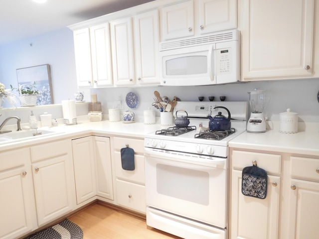3 Executive Dr, Mashpee, MA 02649 - kitchen with white appliances, light wood-type flooring, light countertops, and white cabinets