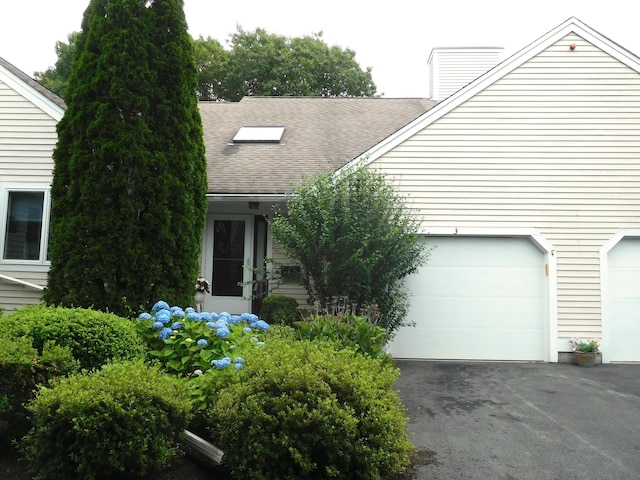 3 Executive Dr, Mashpee, MA 02649 - view of front of property with a garage, asphalt driveway, roof with shingles, and a chimney