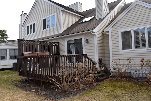 3 Executive Dr, Mashpee, MA 02649 - rear view of property with a deck, a chimney, a shingled roof, and a lawn