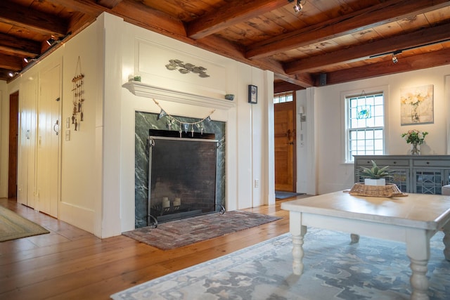 625 Bridge Rd, Eastham, MA 02642 - unfurnished living room with a wooden ceiling with exposed beams, light wood finished floors, and a fireplace