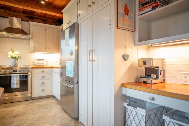 625 Bridge Rd, Eastham, MA 02642 - kitchen with stainless steel appliances, wall chimney exhaust hood, a wood ceiling with exposed beams, decorative backsplash, and butcher block countertops