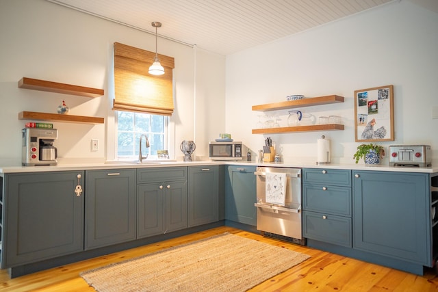 625 Bridge Rd, Eastham, MA 02642 - kitchen with open shelves, appliances with stainless steel finishes, light wood-style flooring, light countertops, and decorative light fixtures