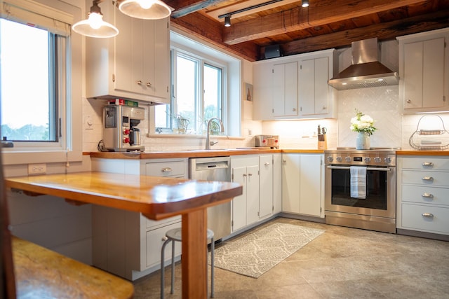 625 Bridge Rd, Eastham, MA 02642 - kitchen with wall chimney range hood, stainless steel appliances, a wooden ceiling with exposed beams, light countertops, and healthy amount of natural light