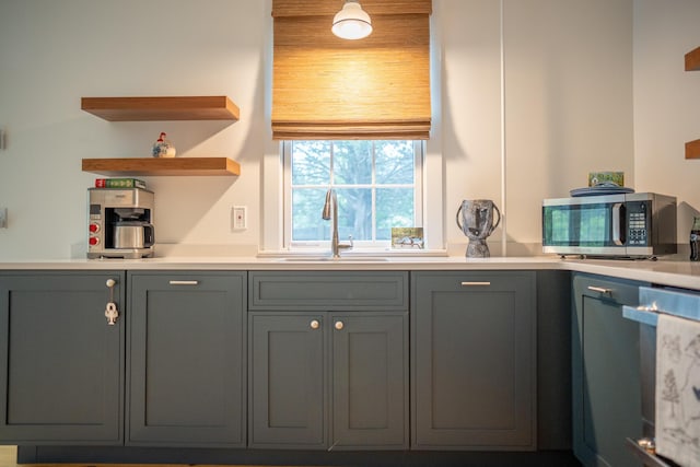 625 Bridge Rd, Eastham, MA 02642 - kitchen with stainless steel microwave, dishwasher, light countertops, and gray cabinetry