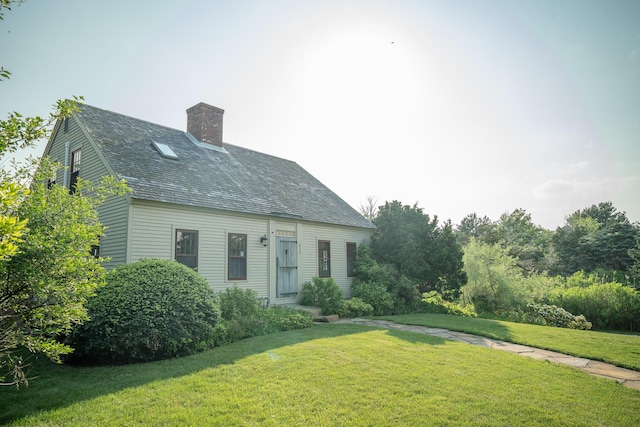 625 Bridge Rd, Eastham, MA 02642 - new england style home with a front lawn and a chimney