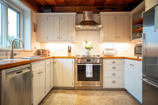 625 Bridge Rd, Eastham, MA 02642 - kitchen featuring wall chimney exhaust hood, appliances with stainless steel finishes, a wooden ceiling with exposed beams, light countertops, and backsplash