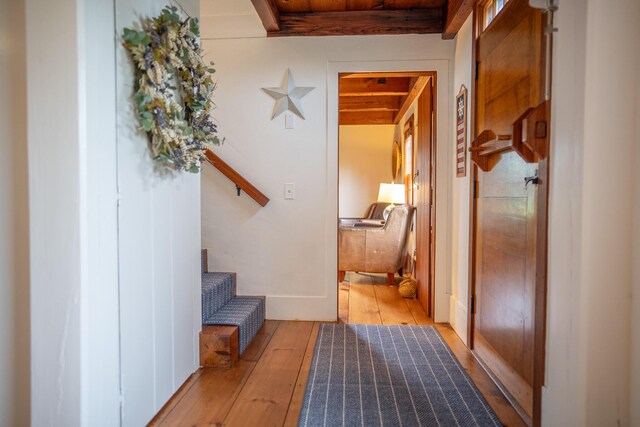 625 Bridge Rd, Eastham, MA 02642 - hallway featuring light wood-style floors, stairway, and a wooden ceiling with exposed beams