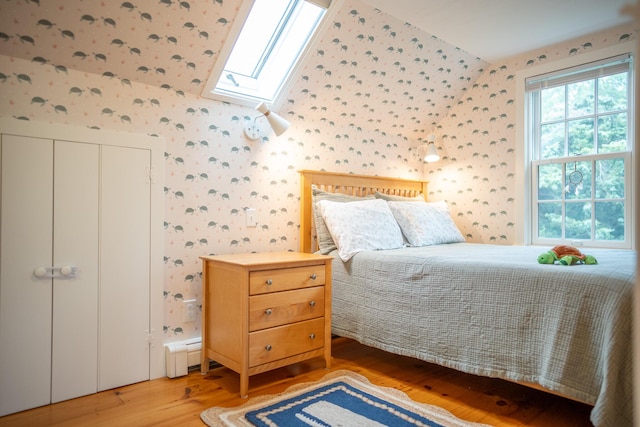 625 Bridge Rd, Eastham, MA 02642 - bedroom with wallpapered walls, wood finished floors, and a skylight