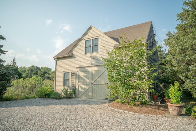 625 Bridge Rd, Eastham, MA 02642 - view of front facade with a shingled roof, driveway, a barn, and an outdoor structure
