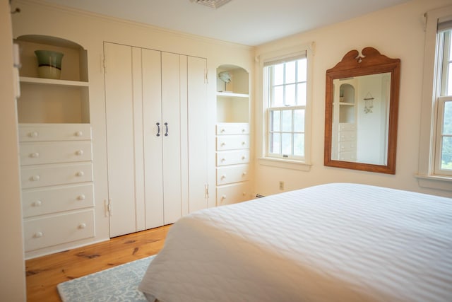 625 Bridge Rd, Eastham, MA 02642 - bedroom featuring wood finished floors, multiple windows, and a closet