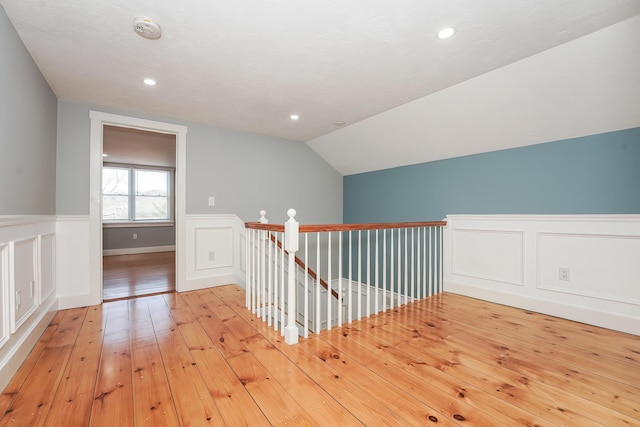 240 Oak St, Centerville, MA 02632 - hallway with wainscoting, lofted ceiling, light wood-style flooring, recessed lighting, and an upstairs landing
