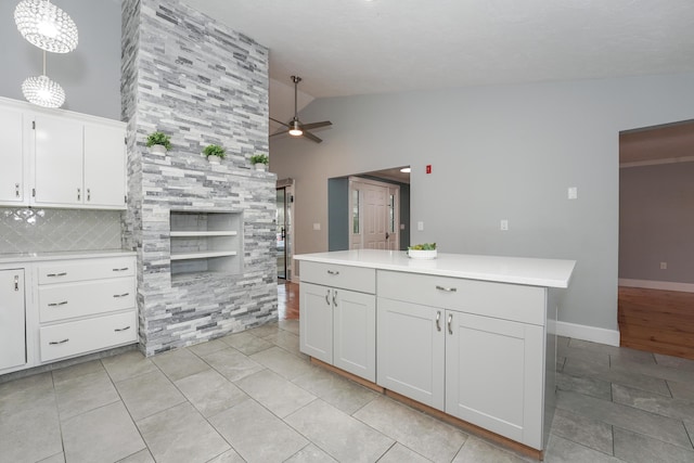 240 Oak St, Centerville, MA 02632 - kitchen with a ceiling fan, light countertops, white cabinetry, a center island, and tasteful backsplash