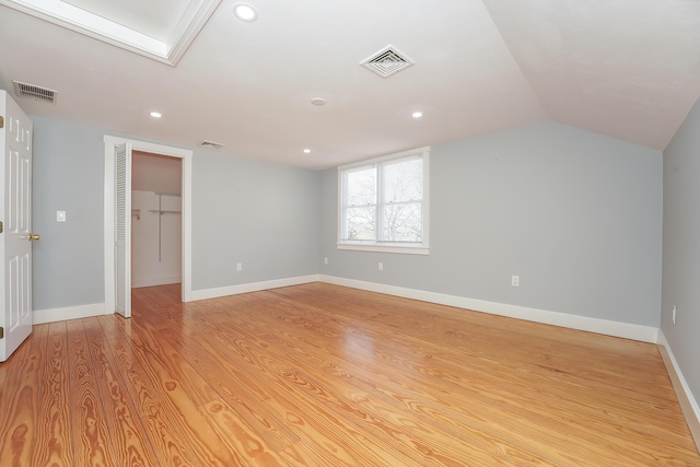 240 Oak St, Centerville, MA 02632 - unfurnished bedroom featuring light wood-type flooring, recessed lighting, lofted ceiling, a walk in closet, and a closet
