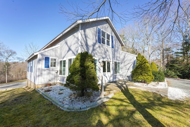 240 Oak St, Centerville, MA 02632 - view of home's exterior featuring board and batten siding and a yard