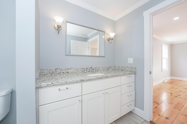 240 Oak St, Centerville, MA 02632 - half bath featuring vanity, toilet, ornamental molding, baseboards, and wood finished floors