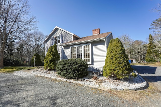 240 Oak St, Centerville, MA 02632 - view of property exterior with a chimney