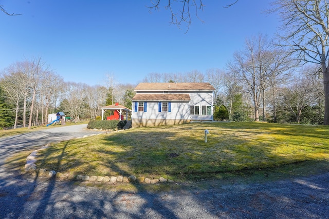 240 Oak St, Centerville, MA 02632 - view of front facade with a playground, a front yard, and driveway