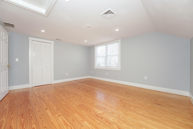 240 Oak St, Centerville, MA 02632 - unfurnished bedroom with light wood-style floors, a closet, lofted ceiling, recessed lighting, and baseboards