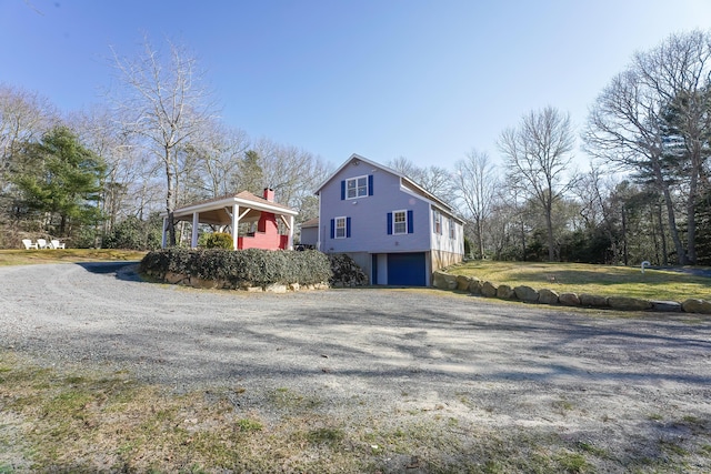 240 Oak St, Centerville, MA 02632 - view of home's exterior featuring gravel driveway and a garage