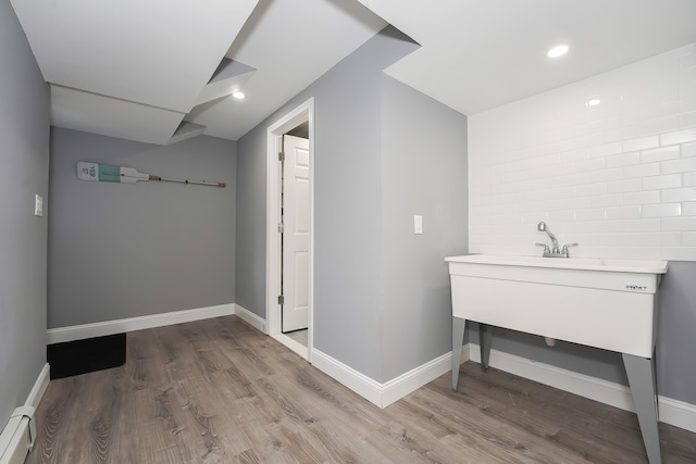 240 Oak St, Centerville, MA 02632 - laundry area with wood finished floors, baseboards, and a baseboard heating unit