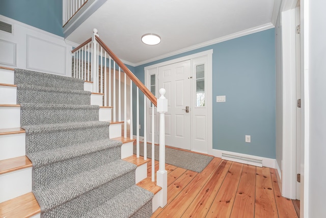 240 Oak St, Centerville, MA 02632 - foyer entrance featuring light wood-type flooring, stairway, crown molding, and baseboards