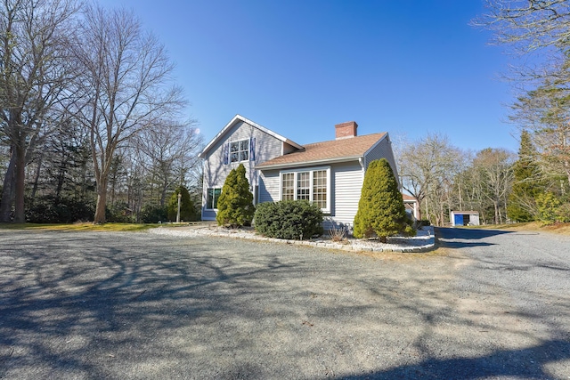 240 Oak St, Centerville, MA 02632 - view of side of home featuring a chimney