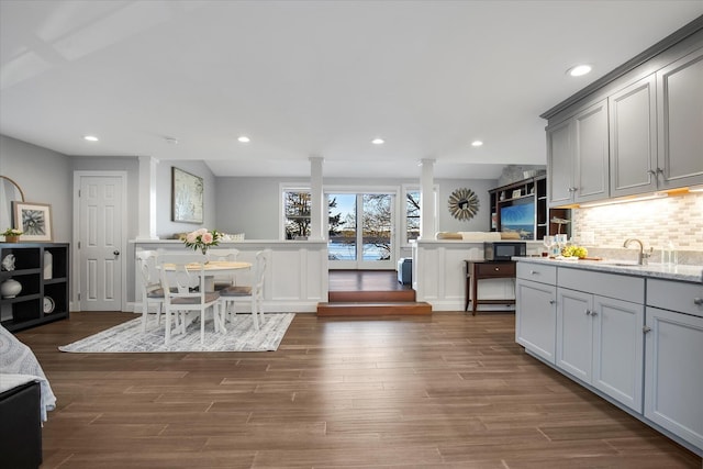 118 Driftwood Ln, South Yarmouth, MA 02664 - kitchen with decorative columns, black microwave, decorative backsplash, gray cabinets, and dark wood-style floors