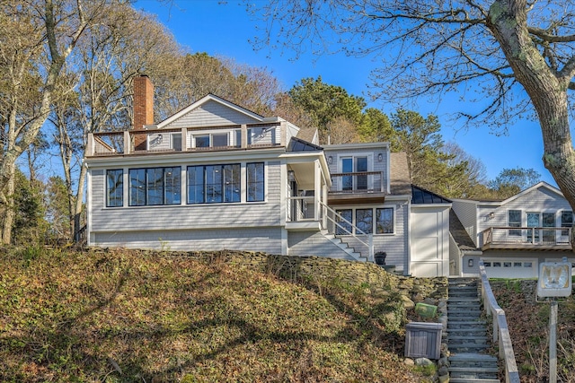 118 Driftwood Ln, South Yarmouth, MA 02664 - rear view of property featuring a balcony, stairs, and a chimney