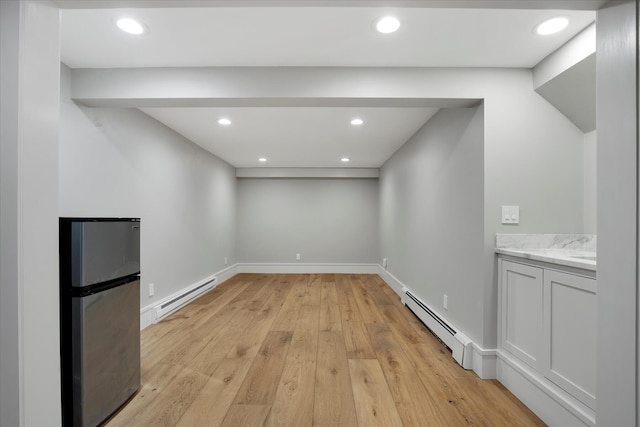 118 Driftwood Ln, South Yarmouth, MA 02664 - basement with a baseboard radiator, freestanding refrigerator, baseboard heating, light wood finished floors, and recessed lighting