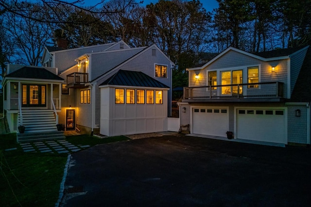 118 Driftwood Ln, South Yarmouth, MA 02664 - back of house featuring a balcony, driveway, a garage, a standing seam roof, and metal roof