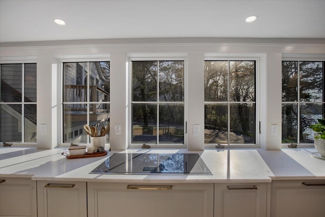118 Driftwood Ln, South Yarmouth, MA 02664 - kitchen view of black electric stovetop, white cabinets, and recessed lighting