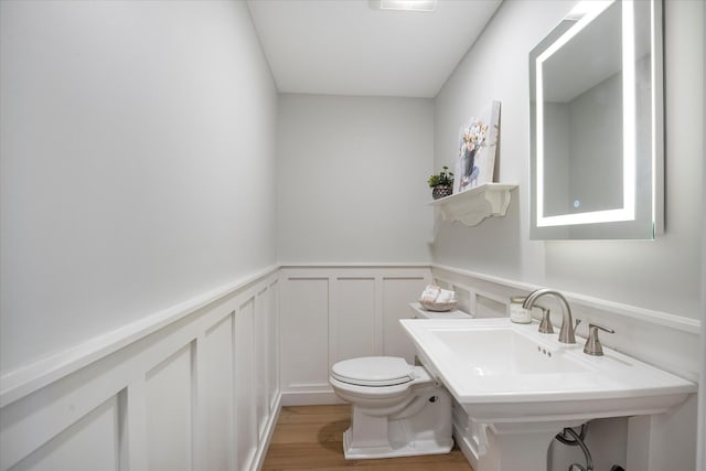118 Driftwood Ln, South Yarmouth, MA 02664 - half bath with toilet, a decorative wall, wood finished floors, and wainscoting