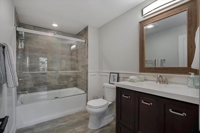 118 Driftwood Ln, South Yarmouth, MA 02664 - bathroom featuring vanity, toilet, combined bath / shower with glass door, a wainscoted wall, and a decorative wall