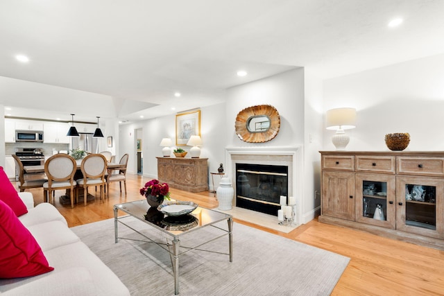 2 Pacific Ave, Mashpee, MA 02649 - living room with recessed lighting, a fireplace with flush hearth, and light wood-style floors
