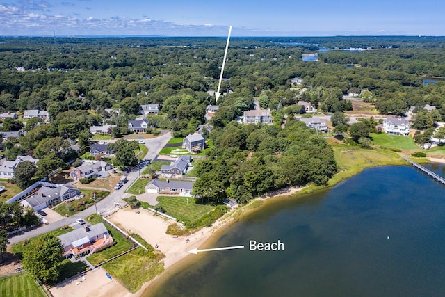 drone / aerial view featuring a water view and a wooded view