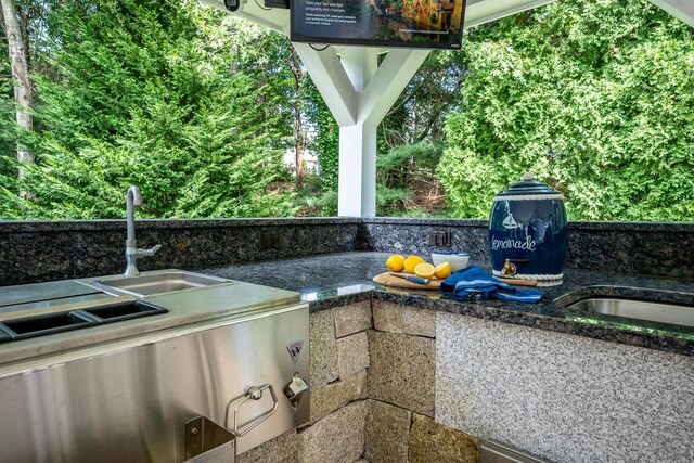 view of patio with area for grilling and sink