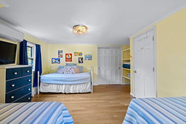 bedroom featuring ornamental molding, hardwood / wood-style floors, and a closet