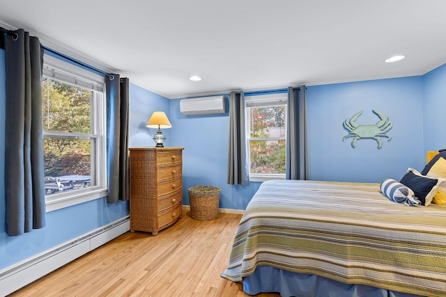 bedroom featuring a baseboard radiator, a wall mounted AC, hardwood / wood-style floors, and multiple windows