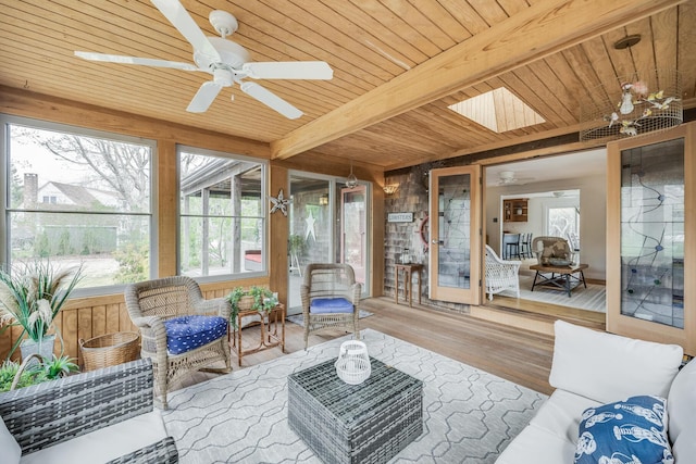 sunroom / solarium with ceiling fan, beam ceiling, and an outdoor living space