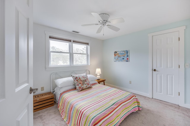 bedroom with light colored carpet, ceiling fan, and baseboards