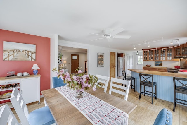 dining room featuring ceiling fan and light wood-style flooring