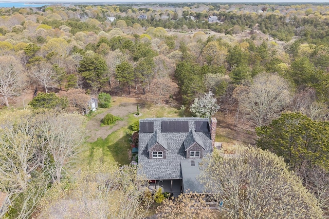 view of subject property featuring a forest
