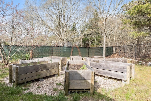 view of yard featuring a vegetable garden and fence